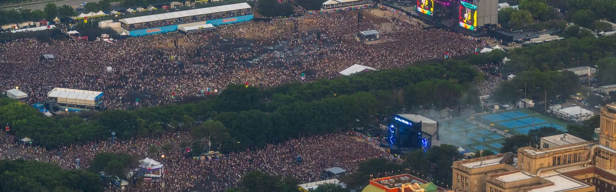 Aerial view of a large city festival with stages, tents and a huge crowd