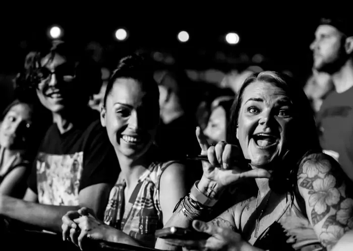 Concert-goers laughing and cheering